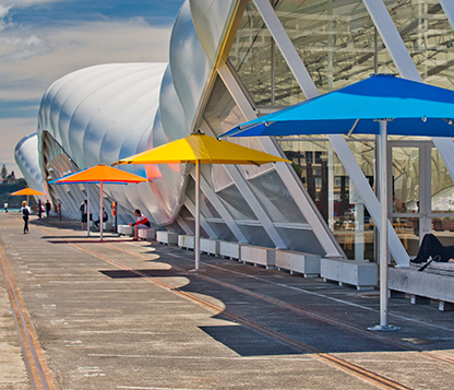 Frankford Nova Giant Telescoping Umbrellas line the outside of a community center building in Melbourne