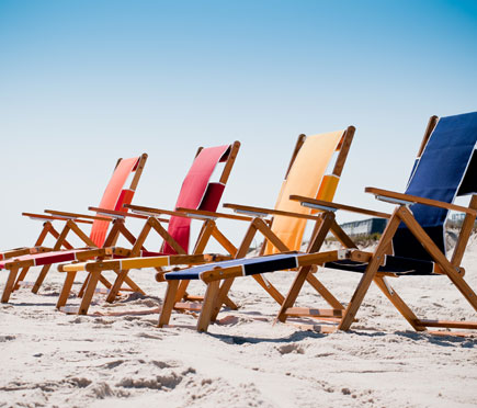 Four Frankford Beach Oakwood Loungers set up on the beach sand