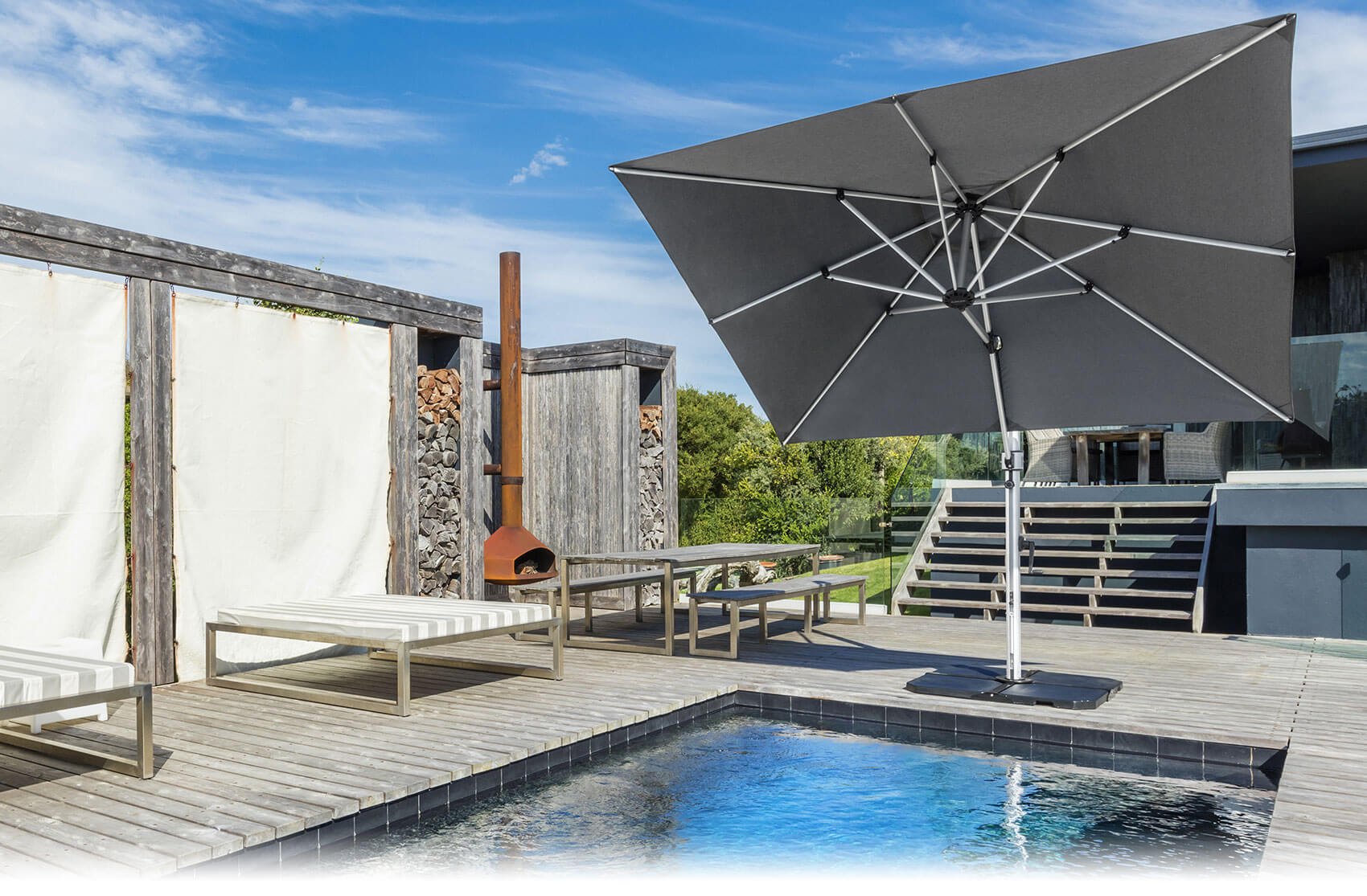 Gray Frankford Cantilever Umbrella shading the pool of a modern home